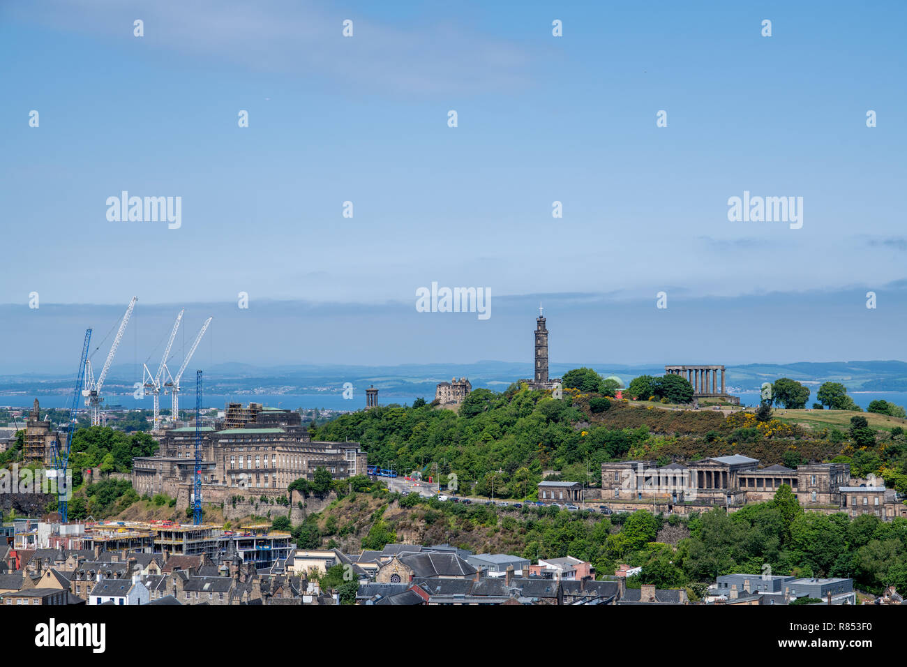 An elevated view of the iconic landmarks of Calton Hill, rooftops and the cityscape of Edinburgh, Scotland, UK. Stock Photo