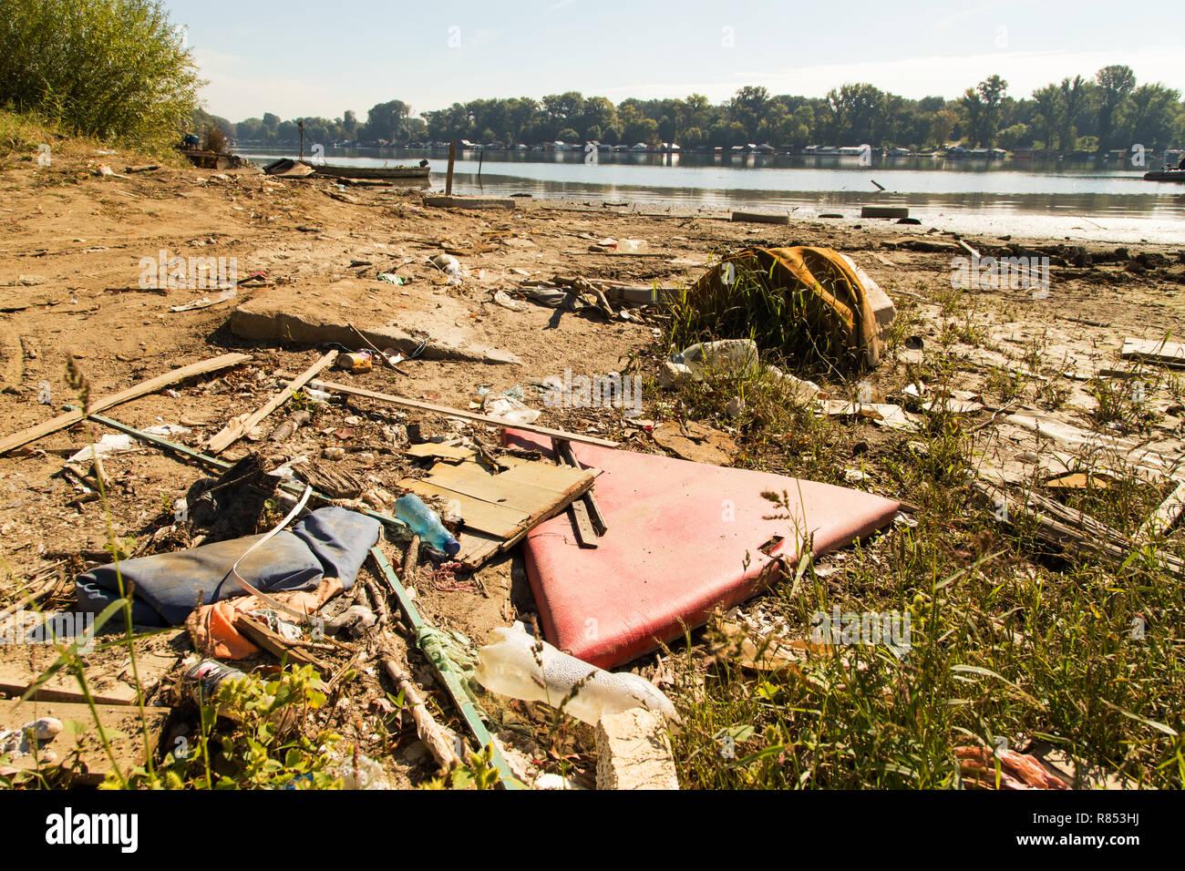 Polluted river bank by some random trash making huge ecological problem in Serbia Stock Photo