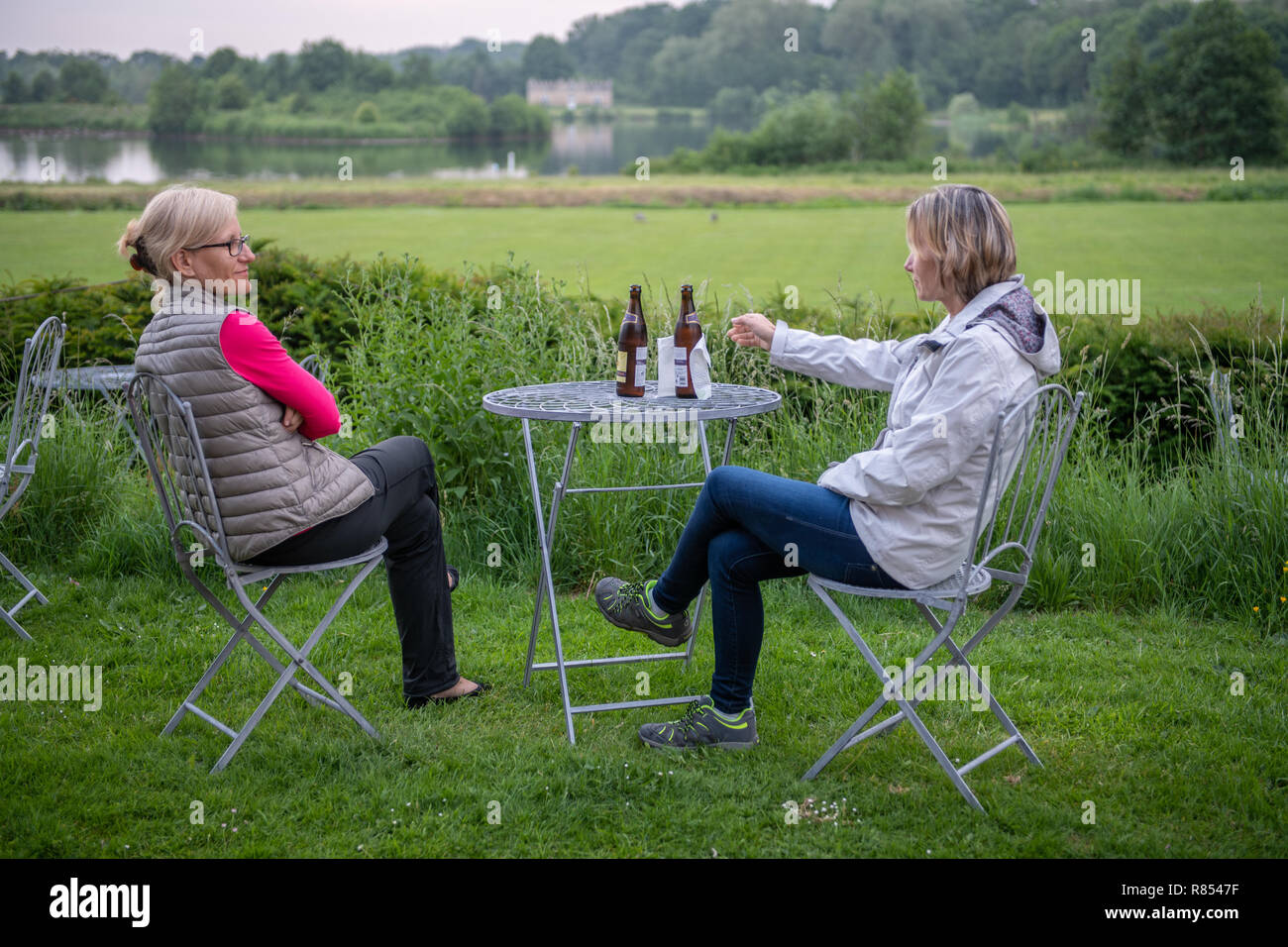 Two women sit hi-res stock photography and images - Alamy