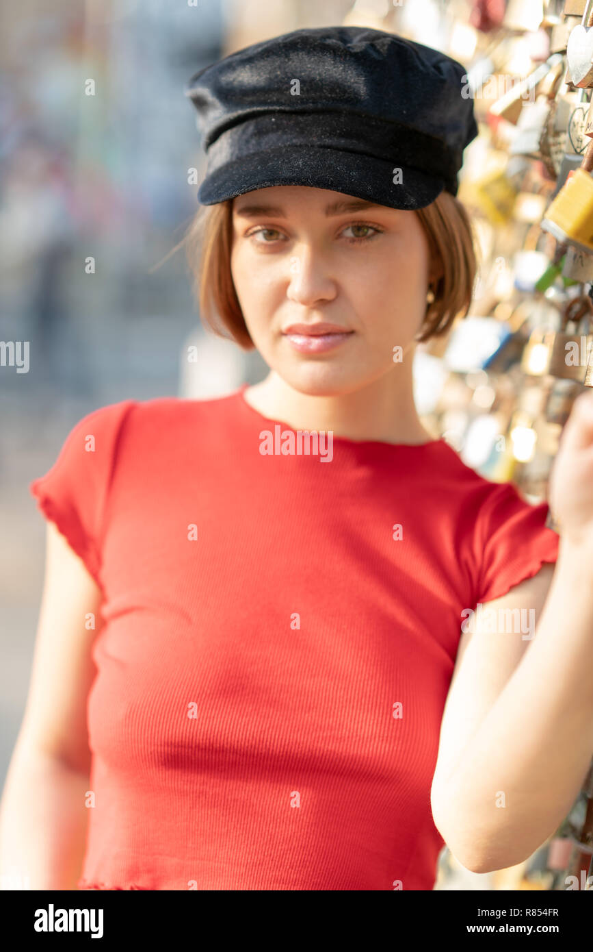 Portrait Of Young Woman With Short Hair Beanie And Red Top In The