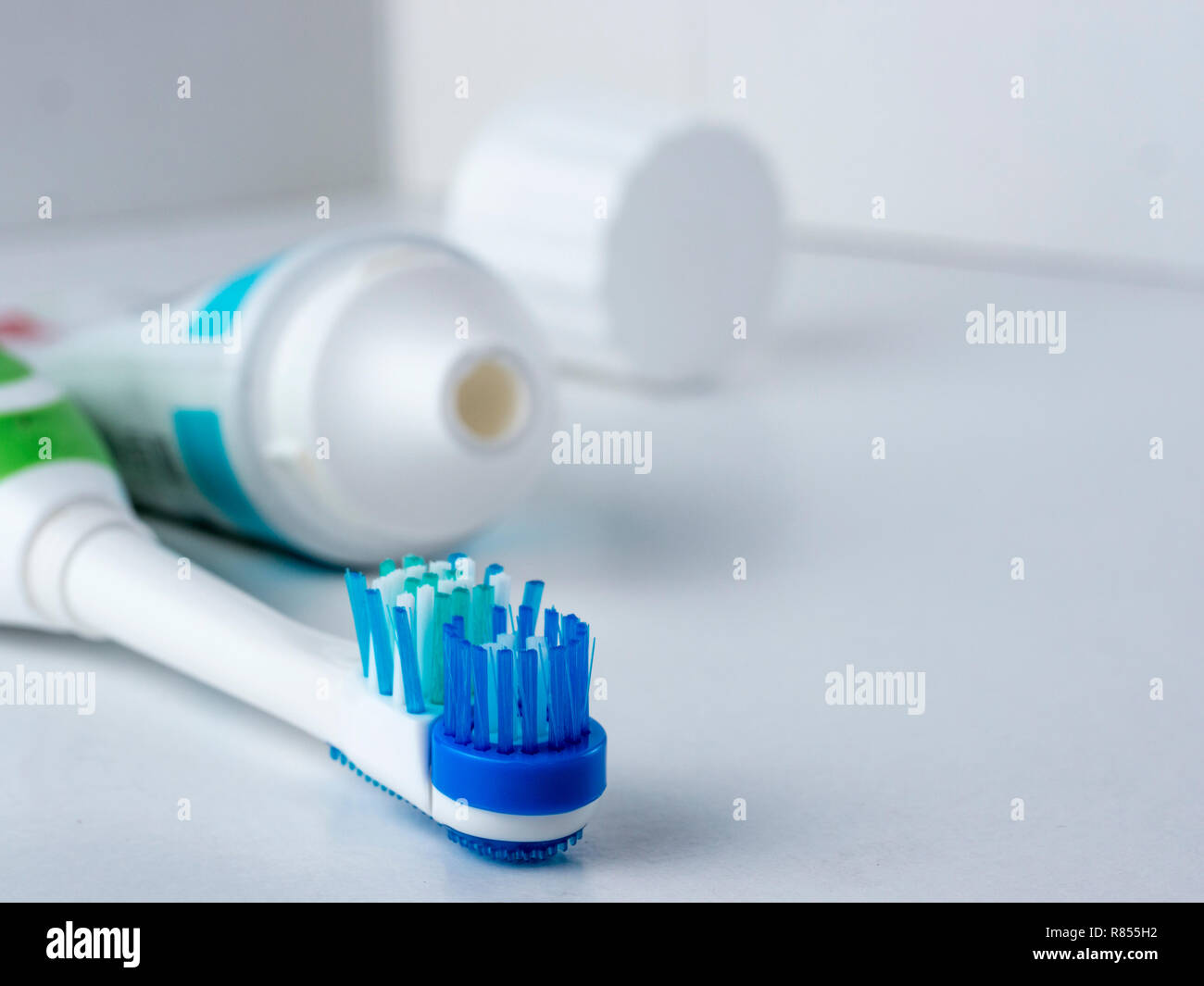 Electric toothbrush on white background. Head electrical toothbrush close up. Electric toothbrush and toothpaste. Copy space Stock Photo