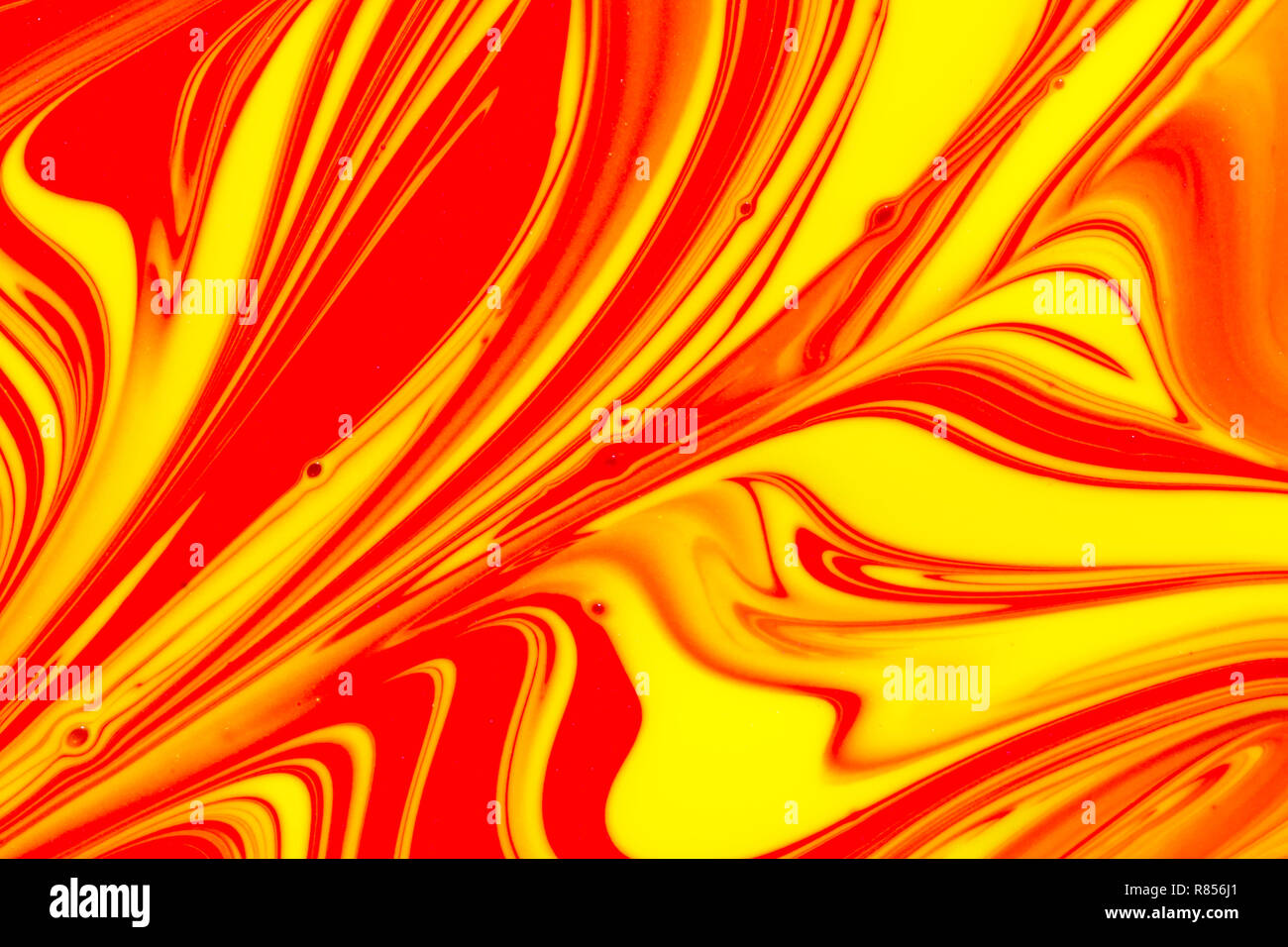 Abstract background of red, orange and yellow swirls of liquid pant Stock Photo