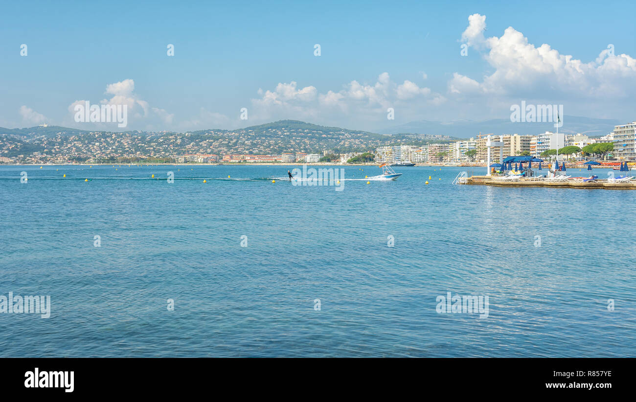 Juan-les-Pins, France, September 19, 2018: Woman water skiing in the Golfe Juan with in the background the hotels of the French city of Juan-les-Pins Stock Photo