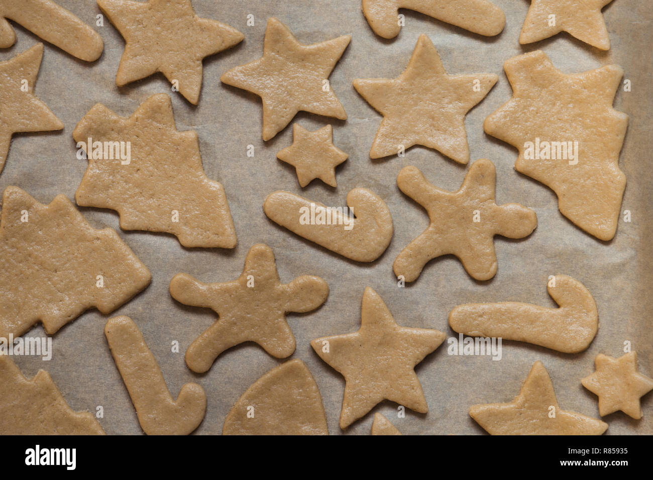 Homemade christmas cookies on parchment. Xmas pattern. Stock Photo