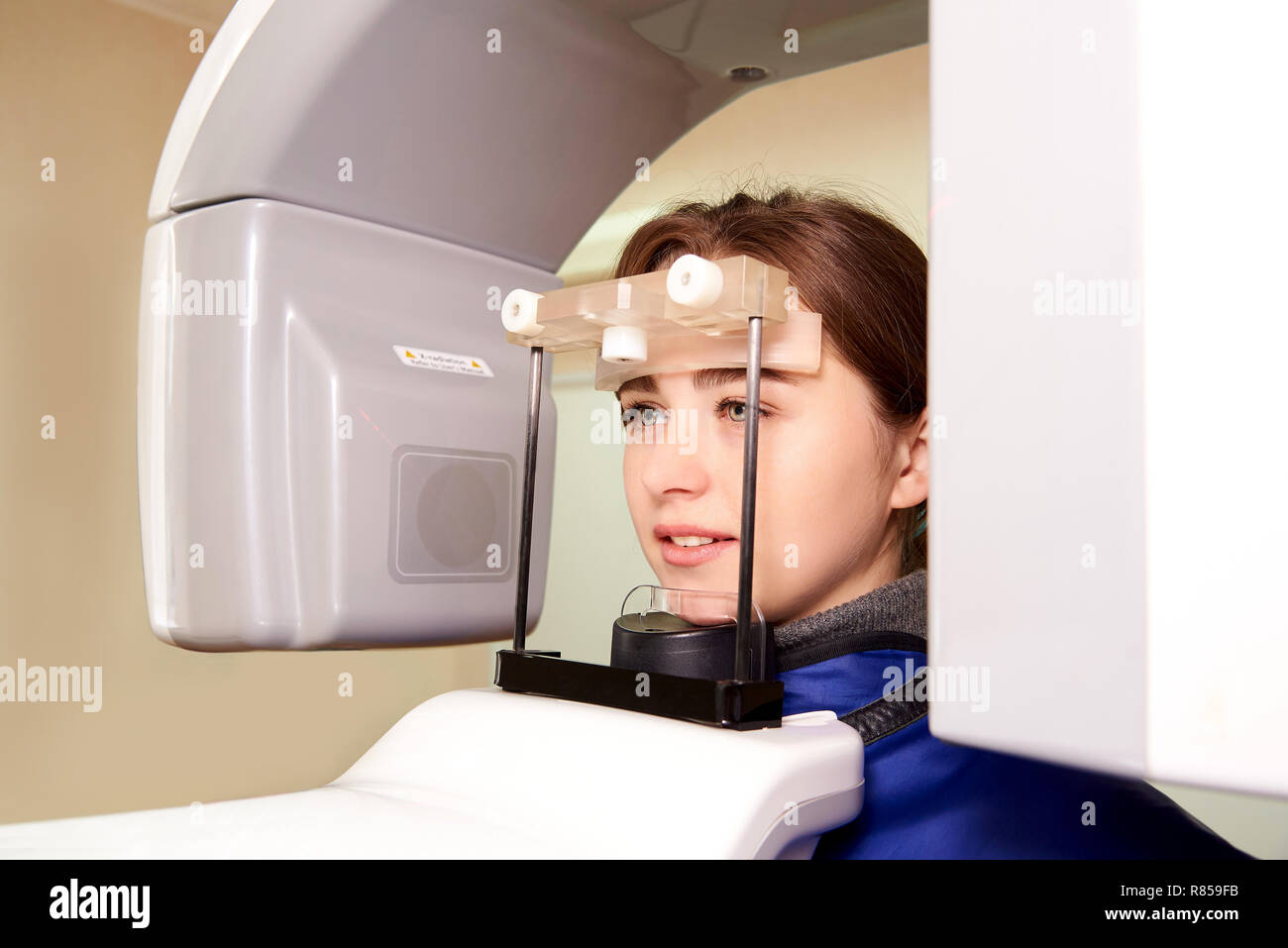 Patient standing in xray machine. Panoramic