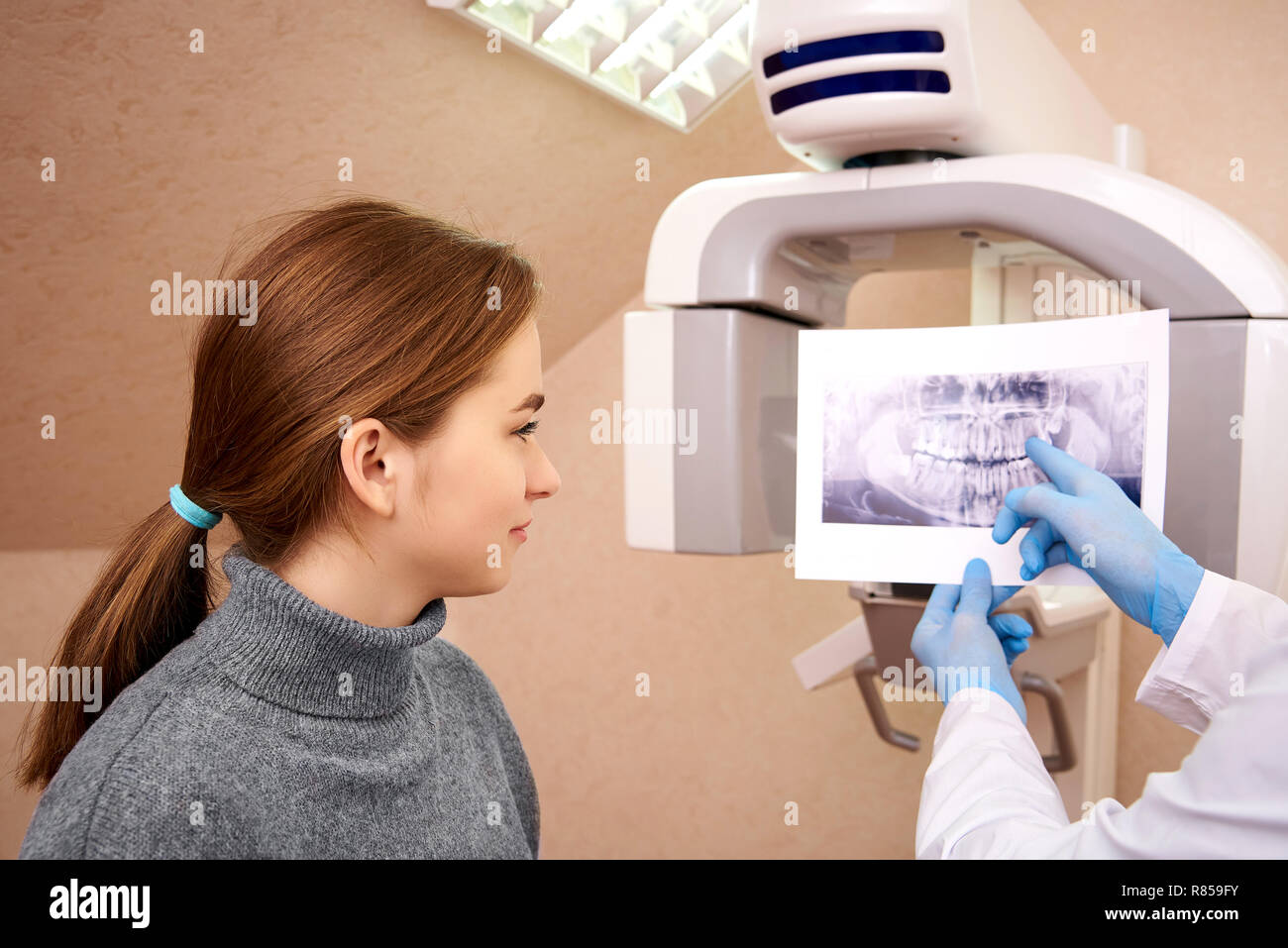 Dentist showing xray to her patient in dental
