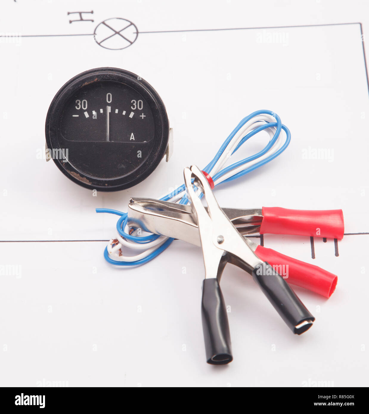 Ammeter and electric clamps on a background of the electric scheme Stock Photo