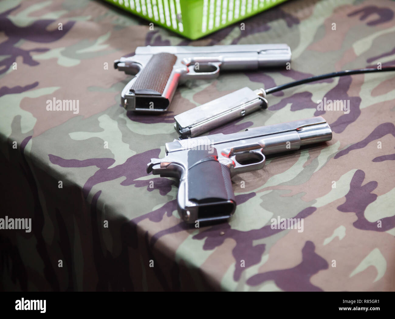 two magnum guns and a gun magazine placed on army camouflage clothes  background in shooting range. Sport, Recreation, Game, Competition,Weapon,  Firear Stock Photo - Alamy