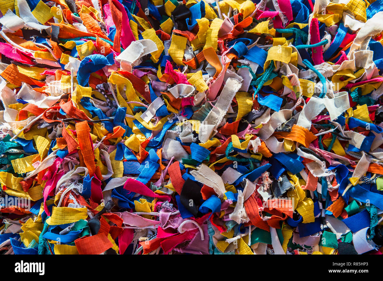 Scraps of colorful fabric in a full frame close-up abstract background Stock Photo