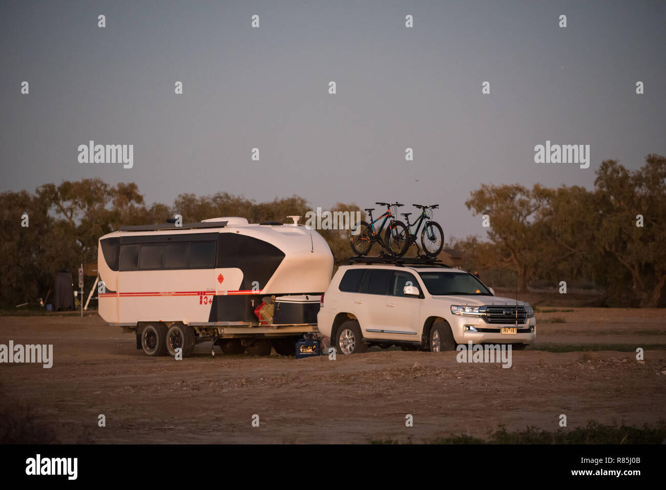 Off road caravan free camping in the Australian outback at sunset Stock