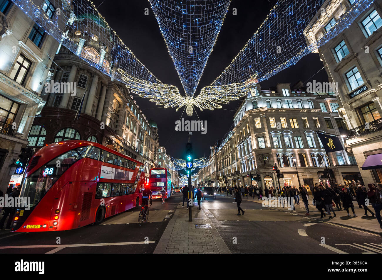 LONDON - NOVEMBER 23, 2018: Black Friday shoppers crowd the sidewalks of the luxury retail district of Regent Street, decorated with Christmas lights. Stock Photo