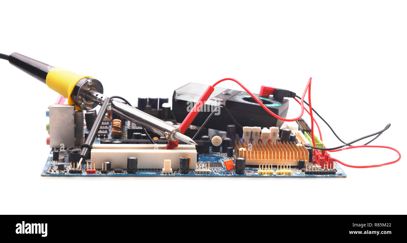 Soldering iron and electronic circuit board on a background of the