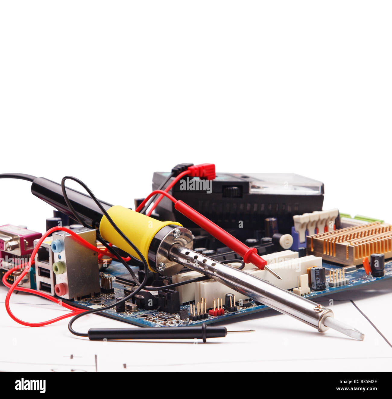 Soldering iron and electronic circuit board on a background of the