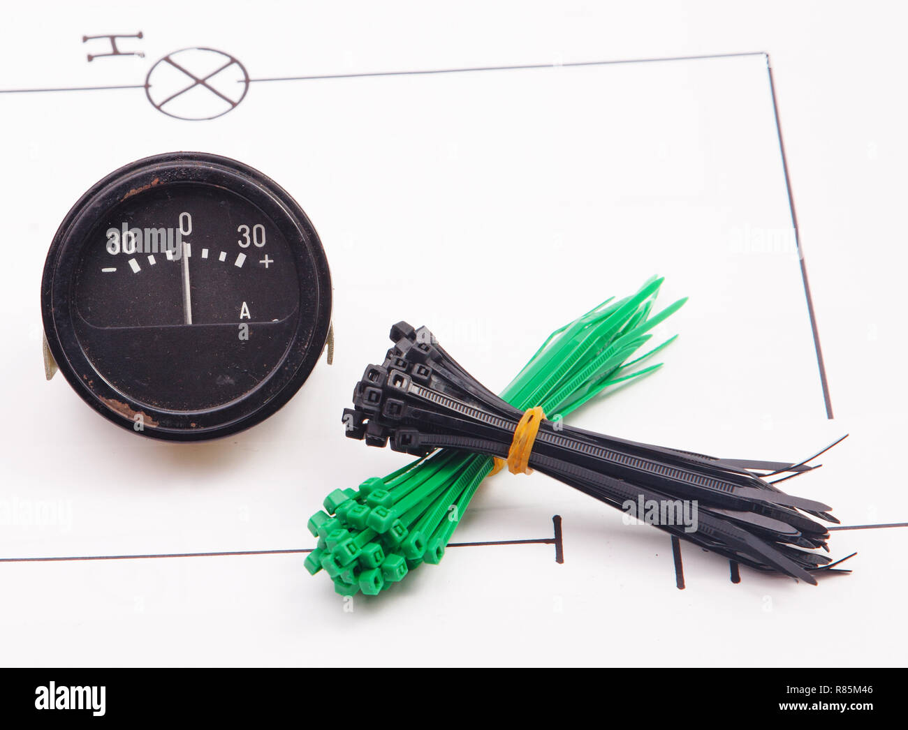 Ammeter and plastic ties on a background of the electric scheme Stock Photo