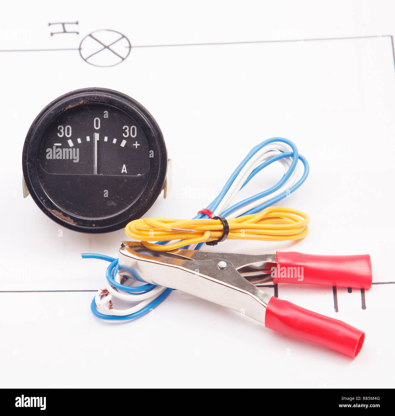 Ammeter and electric clamps on a background of the electric scheme Stock Photo