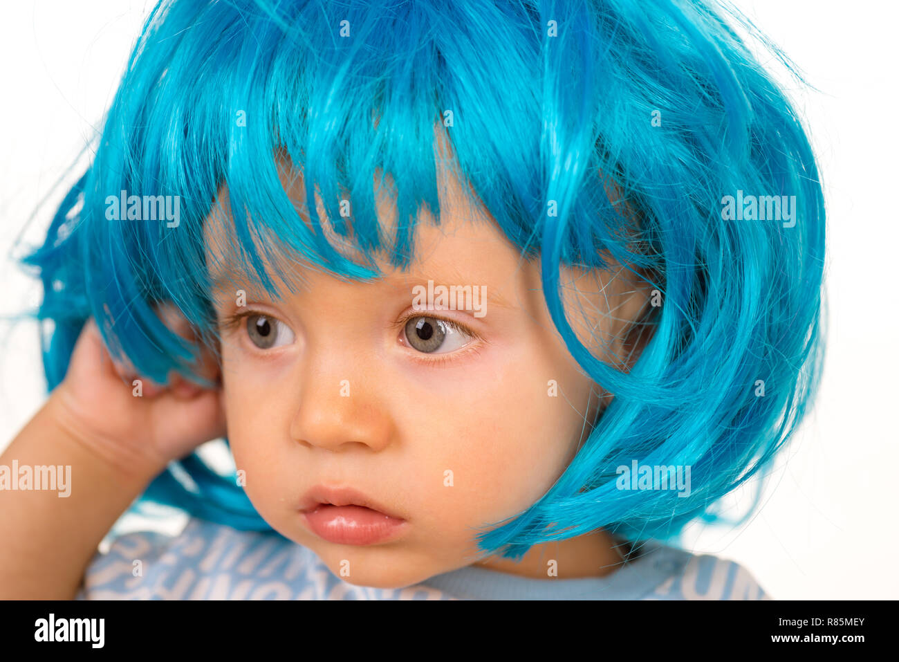 Pure beauty. Adorable little child in fashion wig. Small child wear blue wig hair. Small kid in fancy wig hairstyle. Cute baby with long blue hair. Beauty look hairstyle for cosplay party Pure beauty. Adorable little child in fashion wig. Small child wear blue wig hair. Small kid in fancy wig hairstyle. Cute baby with long blue hair. Beauty look hairstyle for cosplay party