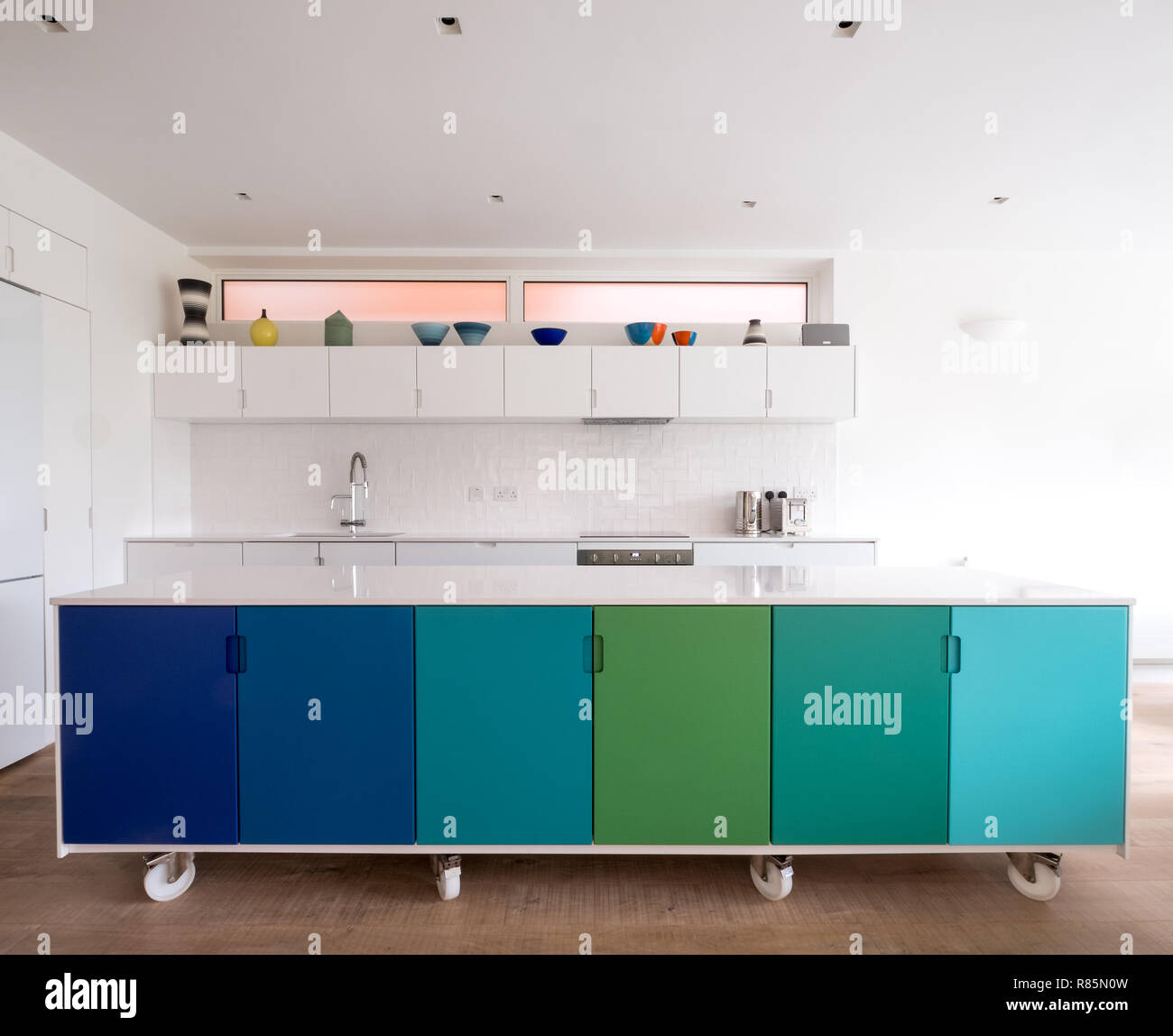 Custom designed kitchen island in open plan kitchen, on industrial