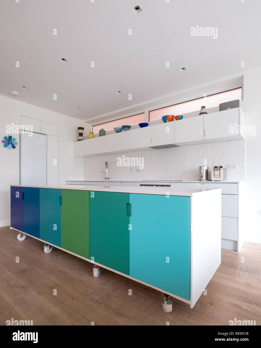 Custom designed kitchen island in open plan kitchen, on industrial
