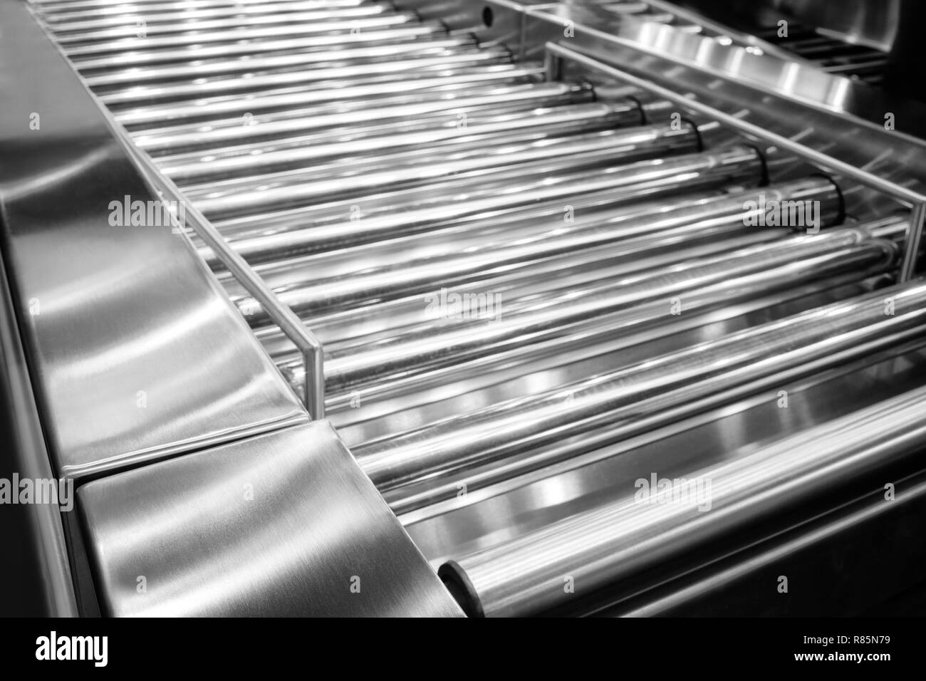 Factory roller conveyor system for transporting crates and aviation baggage Stock Photo