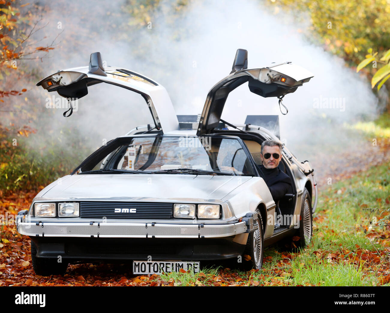 Essen, Germany, 14th Nov, 2018. The "DeLorean DMC-12", known as a time  machine from the film "Back to the Future", is presented by a model on a  preview of the Essen Motor
