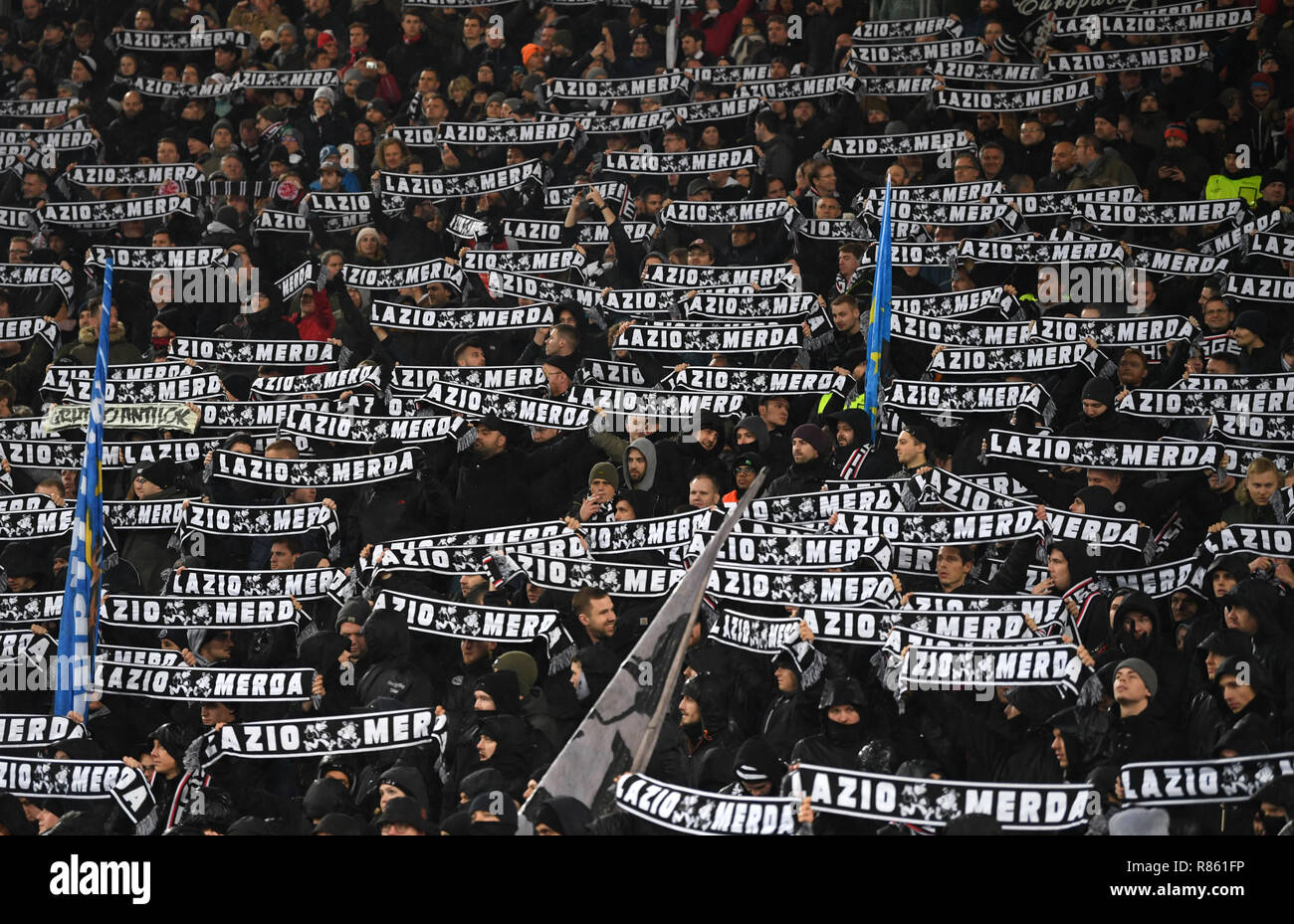 Rome, Italy. 13th Dec, 2018. Soccer: Europa League, Lazio Rome - Eintracht Frankfurt, Group stage, Group H, 6th matchday in the Olympic Stadium. The Frankfurt fans hold up scarves with the inscription 'Lazio Merda' before the game. Credit: Arne Dedert/dpa/Alamy Live News Stock Photo