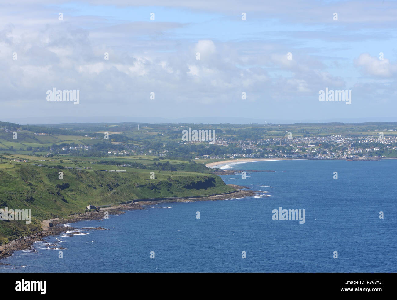 The town of Ballycastle and the sandy Ballycastle beach from the basalt cliffs of Fair Head. Ballycastle, Antrim, Northern Ireland. Stock Photo