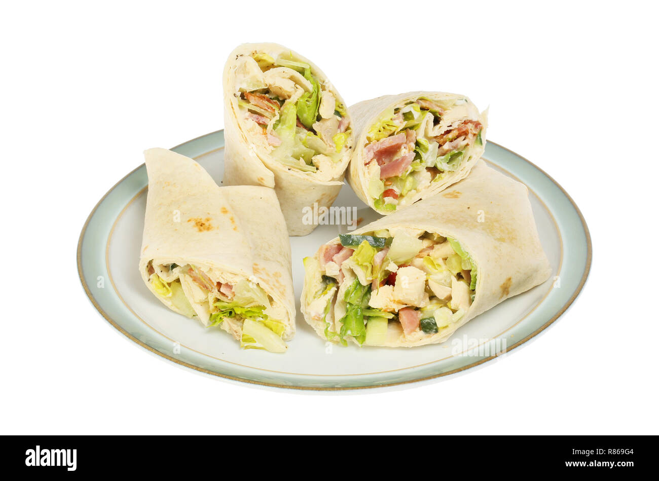 Chicken, bacon and lettuce sandwich wraps on a plate isolated against white Stock Photo