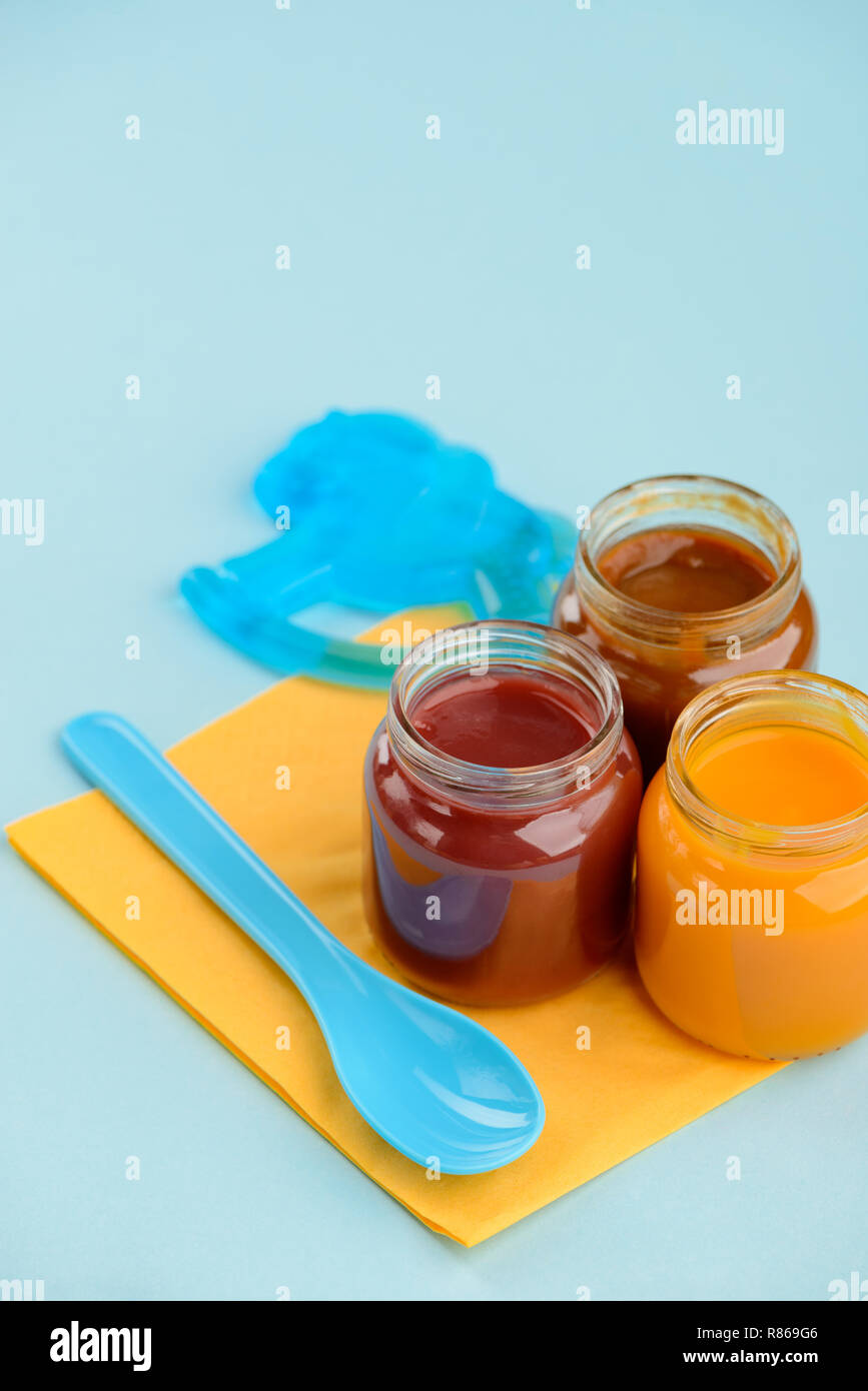 Baby food, teether and spoon Stock Photo