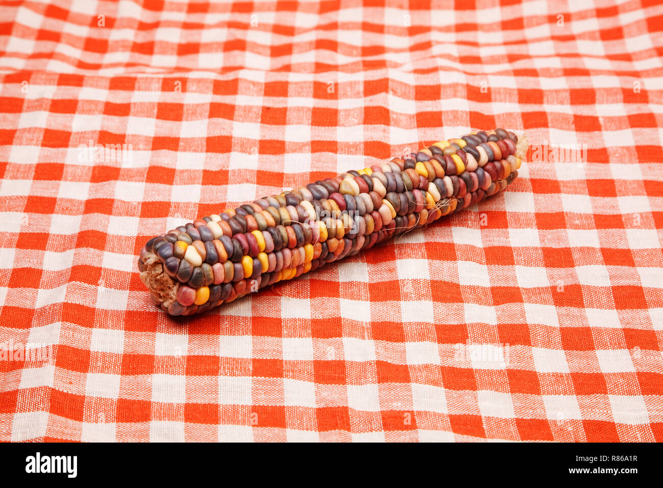 Corn on tablecloth red and white checkered wavy texture background Stock Photo