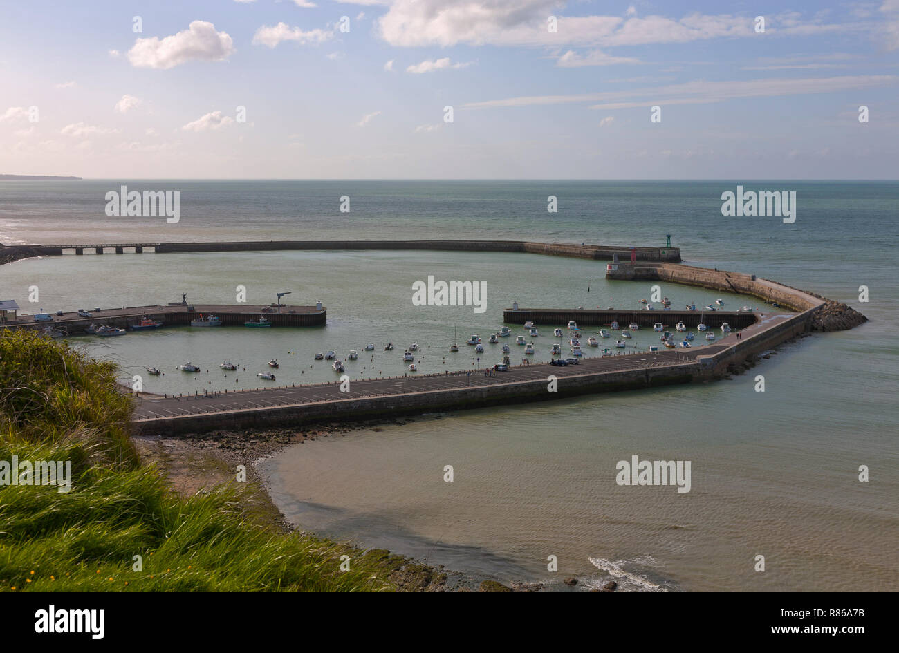 The harbour of Port-en-Bessin-Huppain in Normandy, France, on the English Channel, at sunset. Aerial view, between low and high tide. Stock Photo