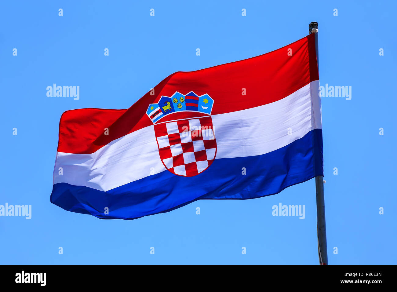 National flag of Croatia flying in blue sky Stock Photo