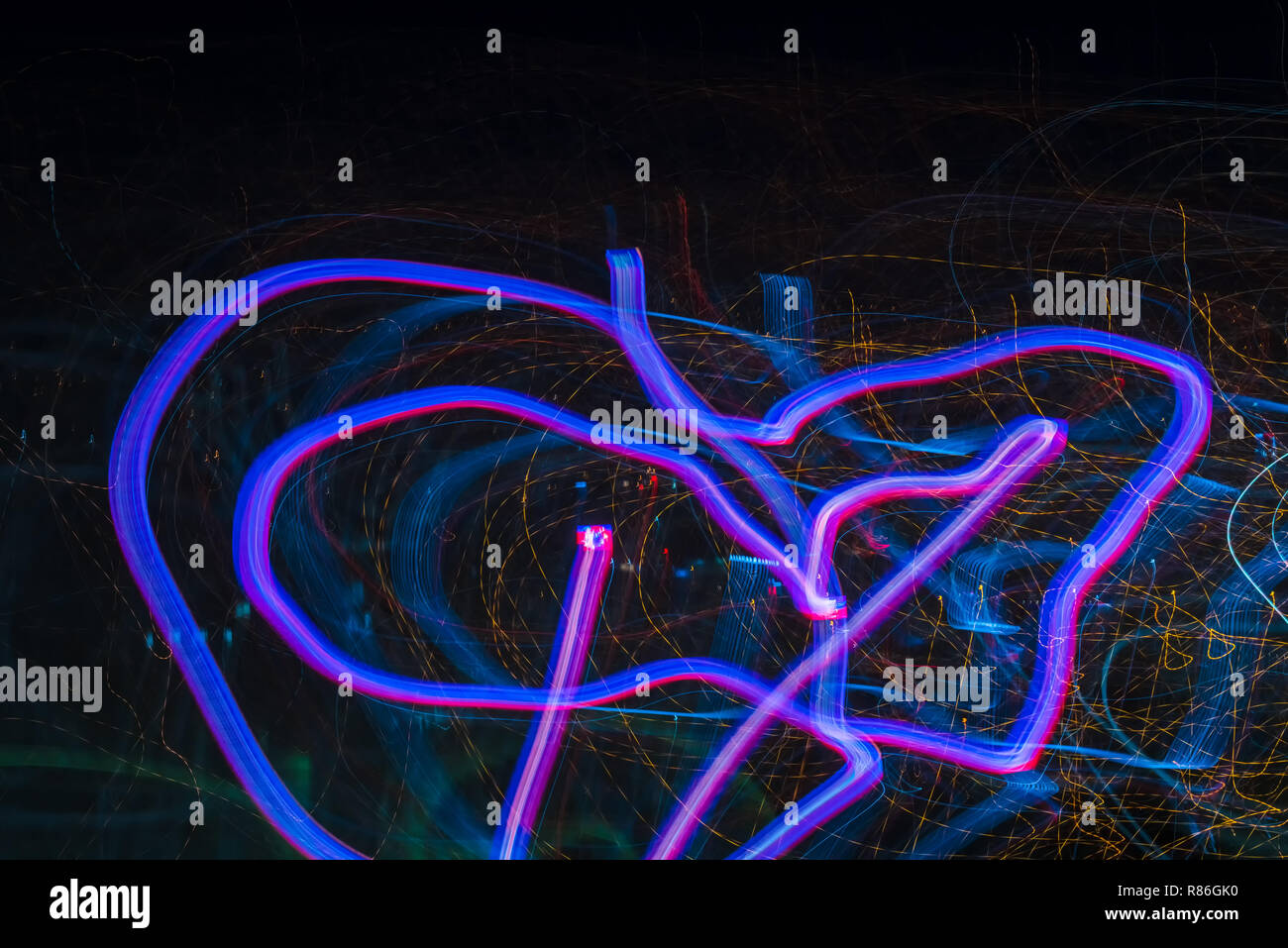 Bright abstract spiral patterns from colored light strips on a black background Stock Photo