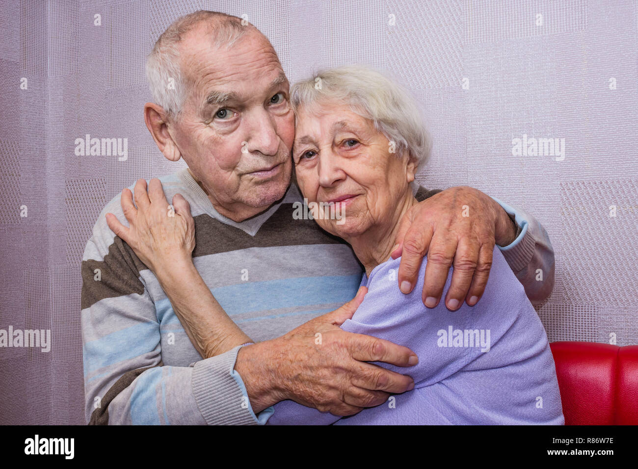 Happy affectionate mature old man and woman embracing looking at camera Stock Photo Alamy
