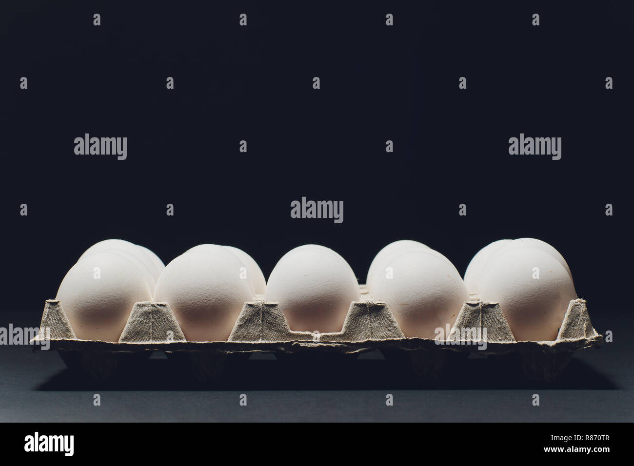 Several white eggs in an egg carton Stock Photo - Alamy