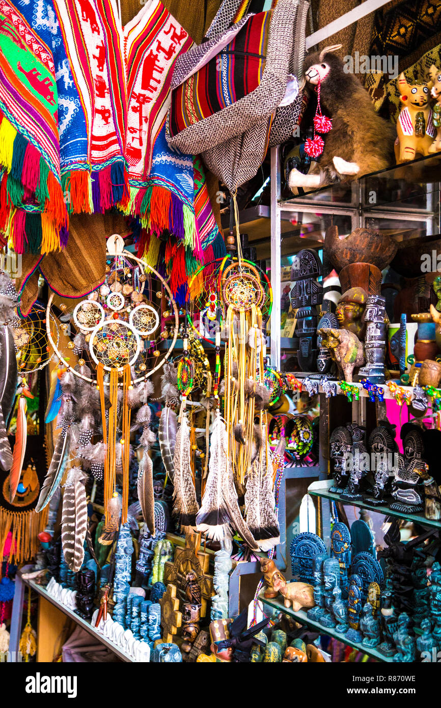 Stall with souvenir figurines and dreamcatchers at Pisac market in the Sacred Valley, Peru Stock Photo