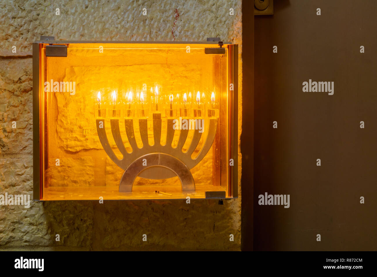 Traditional Menorah (Hanukkah Lamp), with olive oil candles, in the
