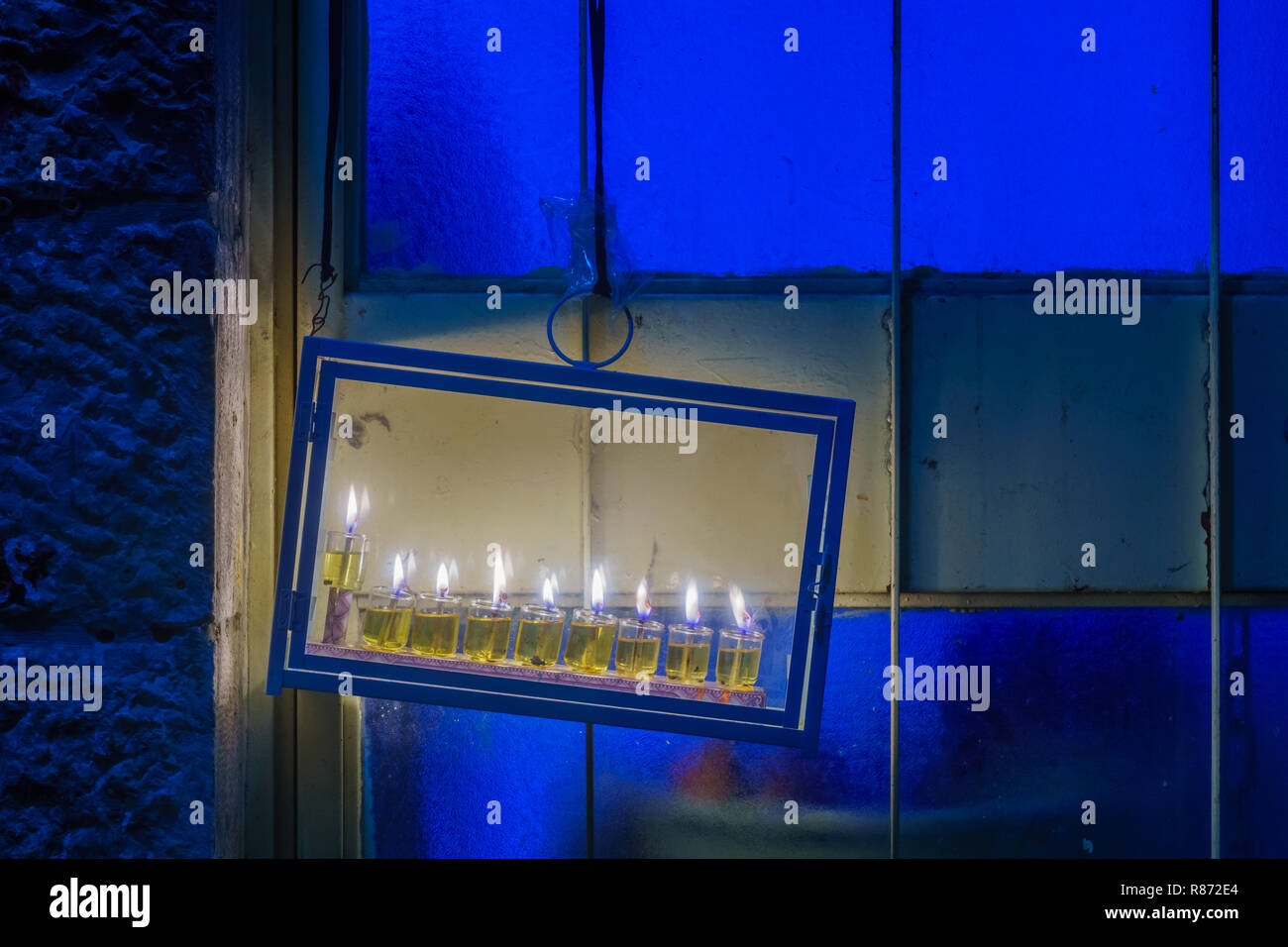Traditional Menorah (Hanukkah Lamp), with olive oil candles, in the