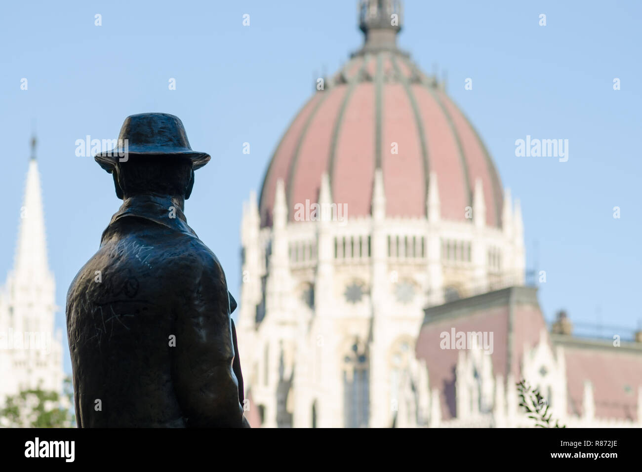 Statue of Imre Nagy, with the dome of the Hungarian Parliament in the ...