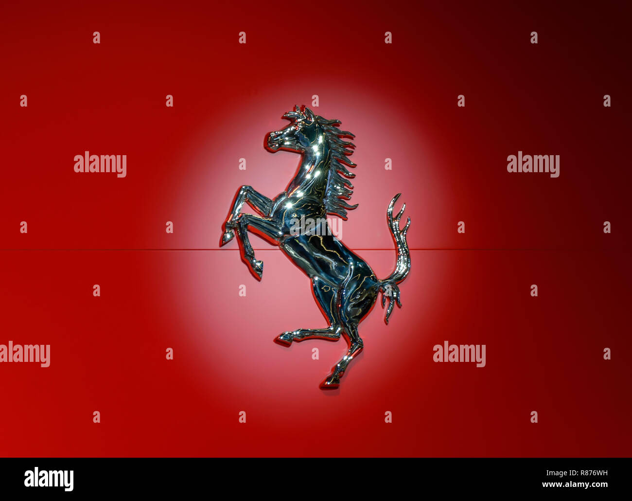 FRANKFURT - SEP 2017: Ferrari horse logo in metallic on red background in a light spot at IAA Frankfurt Motor Show Stock Photo