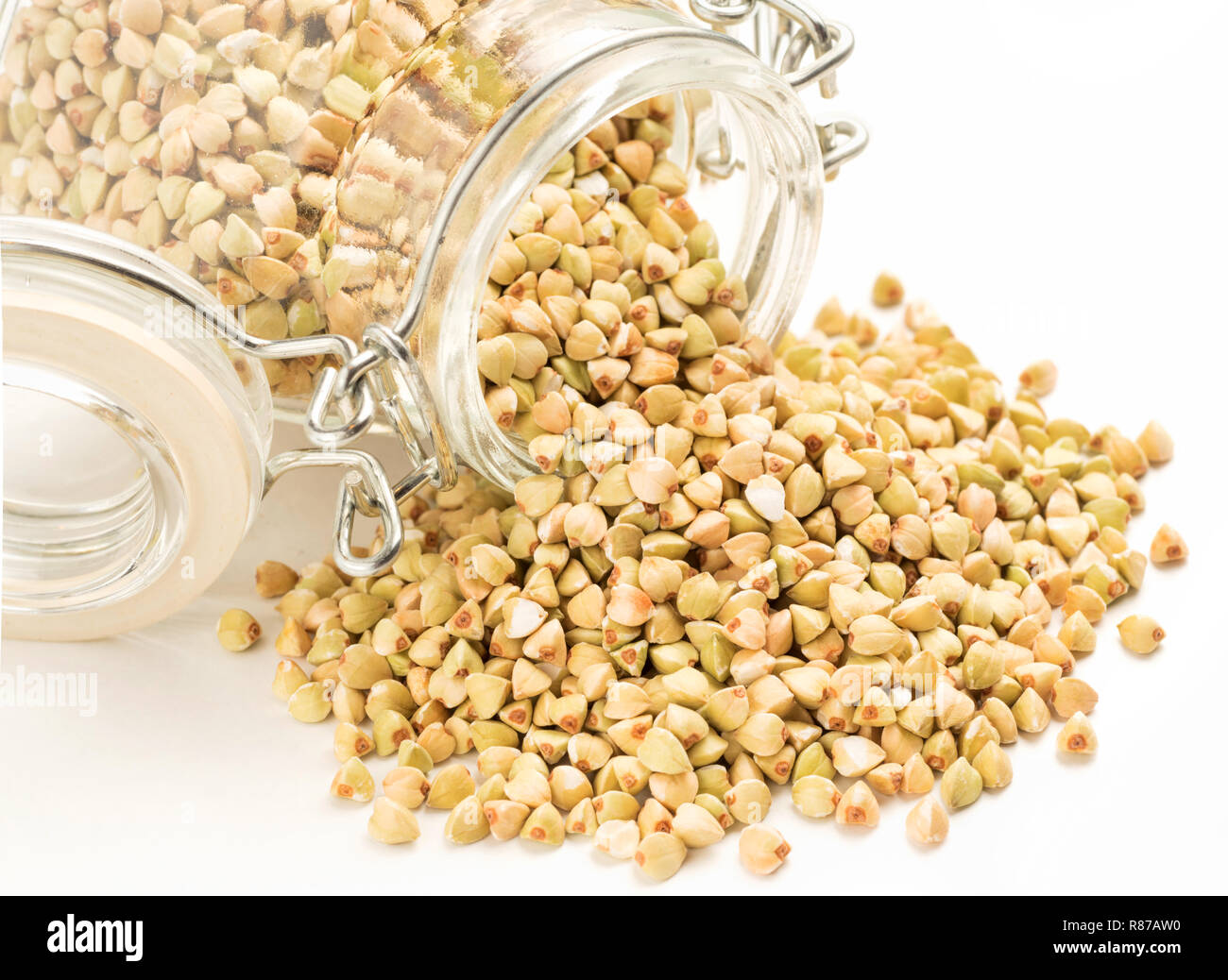 Raw green buckwheat in bank isolated on white background. Healthy food and diet concept Stock Photo