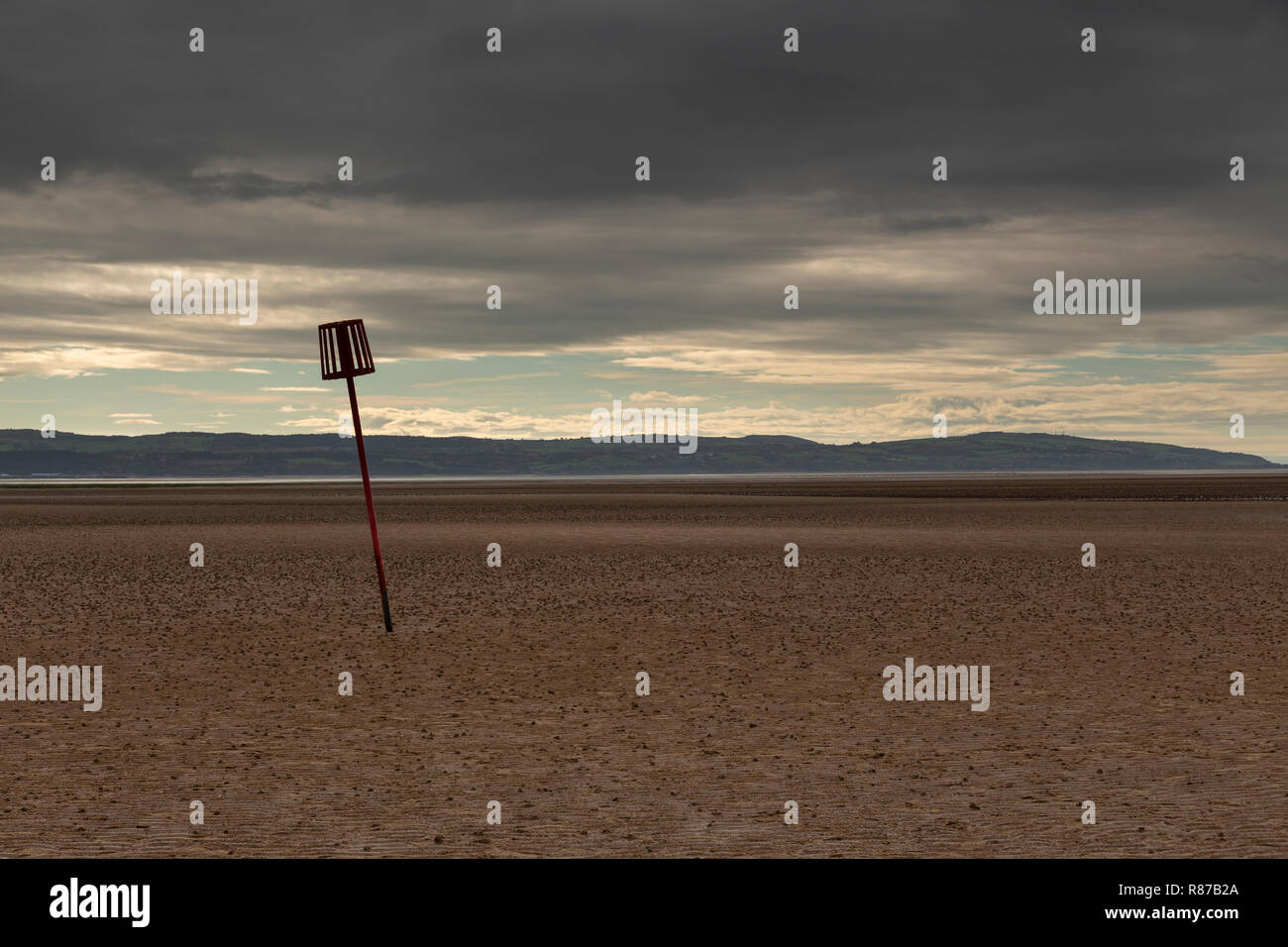 Marker post in the sand at West Kirby, Wirral, England Stock Photo