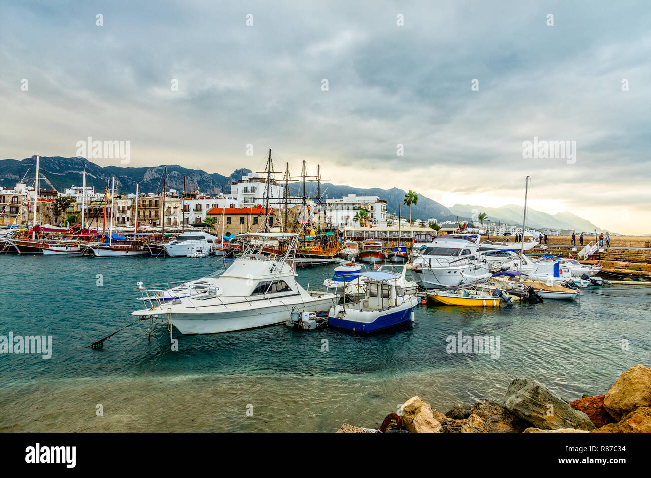 Kyrenia or Girne  historical city center, view to marina with many yachts and boats with mountains in the background, North Cyprus Stock Photo