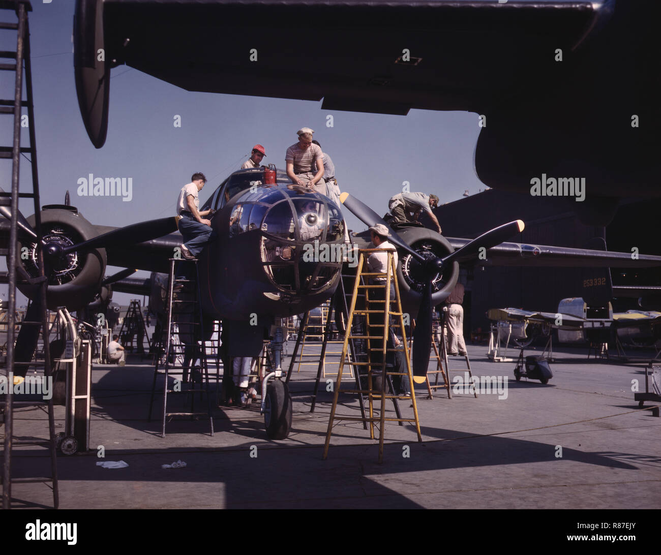 Employees on the 'Sunshine' Assembly Line Putting Finishing Touches on B-25 Bomber, North American Aviation, Inc., Inglewood, California, USA, Alfred T Palmer, U.S. Office of War Information, October 1942 Stock Photo