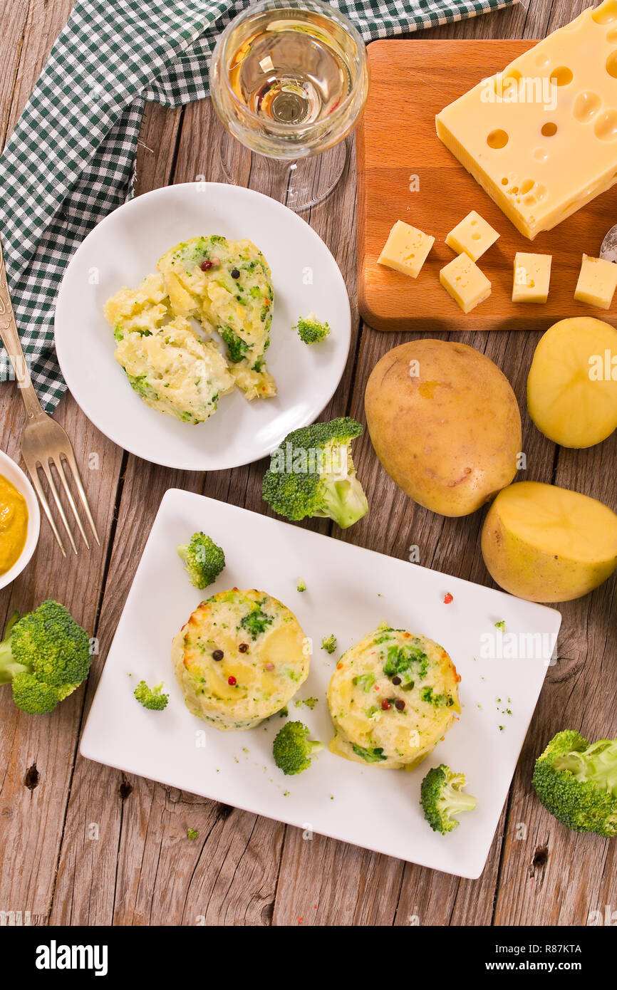 Potato gratins with broccoli florets. Stock Photo