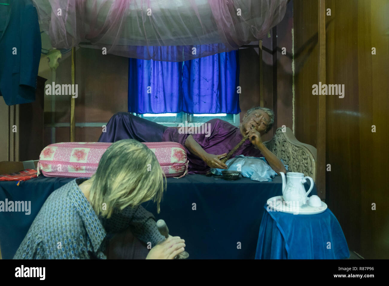 Exhibit showing the smoking of opium at the Drug Elimination Museum in Yangon, Myanmar. Stock Photo