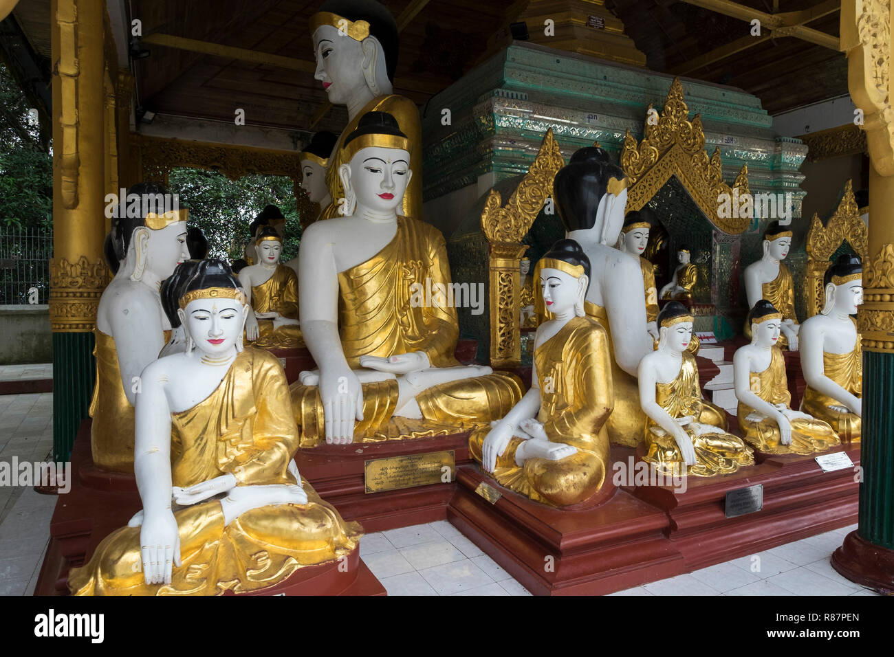 Many Buddhas together at the big Shwedagon Pagoda in Yangon, Myanmar. Stock Photo