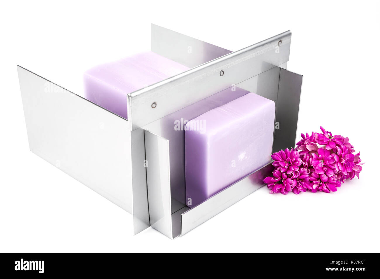 Stainless steel soap cutting tool with handmade soap loaf inside on the