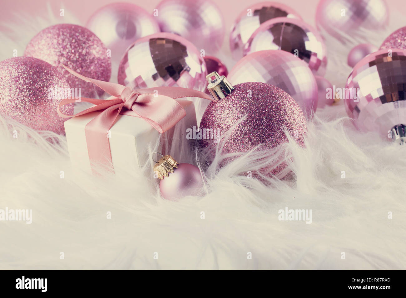 Pink Christmas decorations on white fur Stock Photo