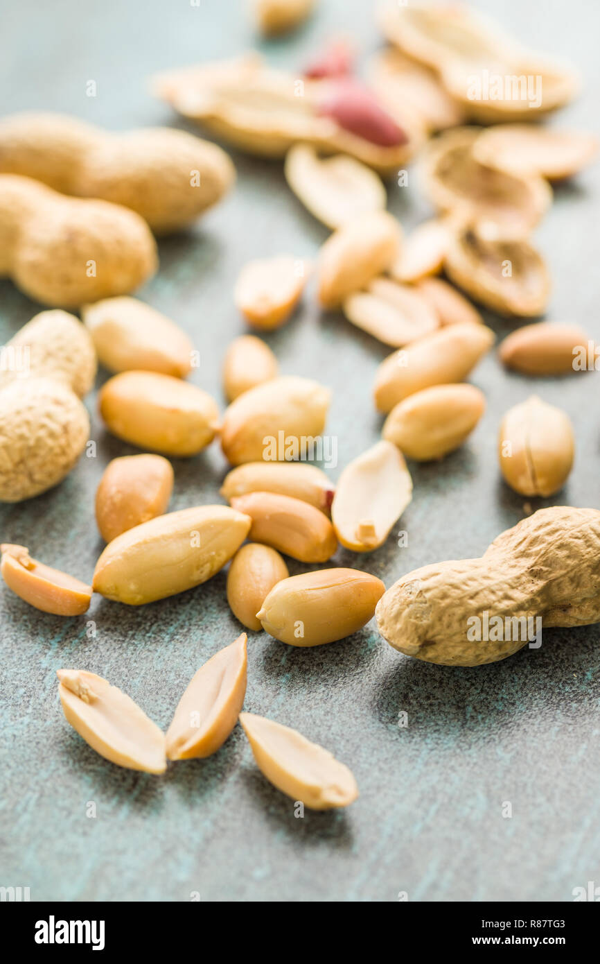 The dried peanuts. Groundnuts on old table. Stock Photo