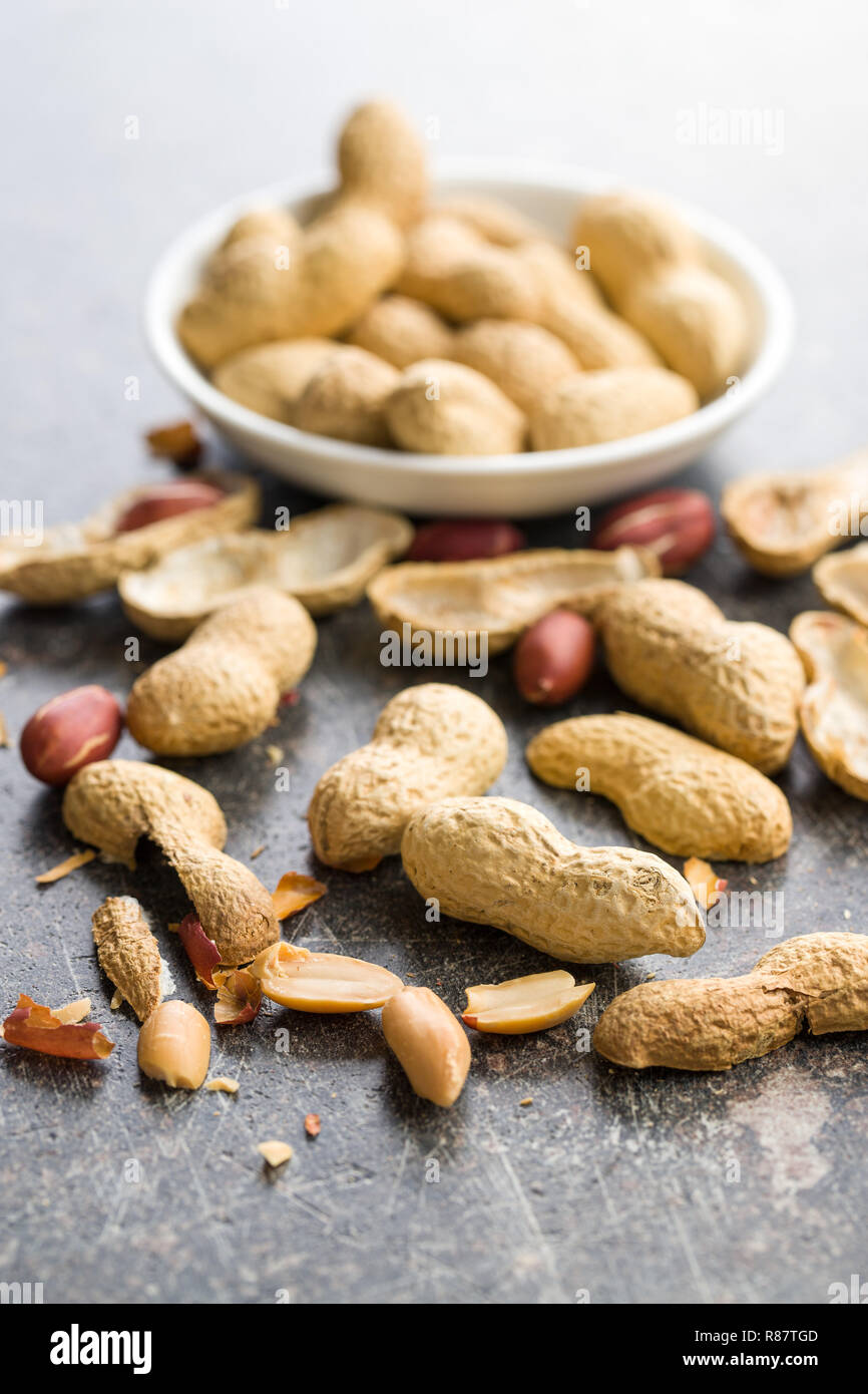 The dried peanuts. Groundnuts on old table. Stock Photo